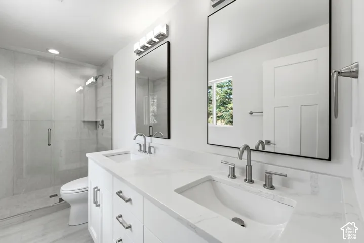 Dual vanity with undermount sinks, stone countertops, and brushed nickel fixtures