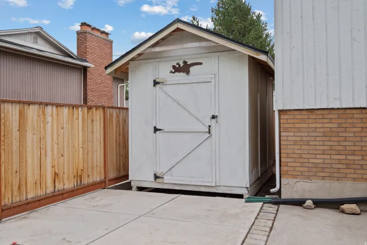 White storage shed with a sloped roof
