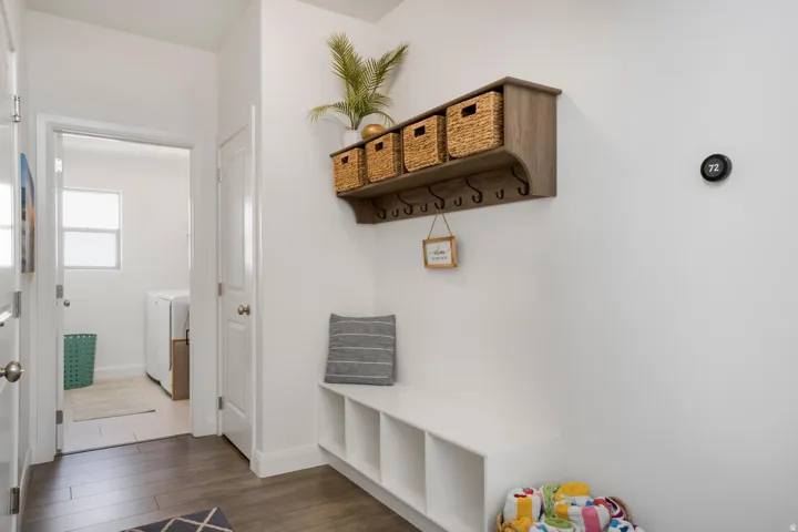 Wood-finish flooring leading to a built-in bench with storage cubbies