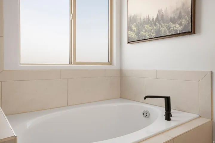 Built-in soaking tub with a deck-mounted matte black faucet