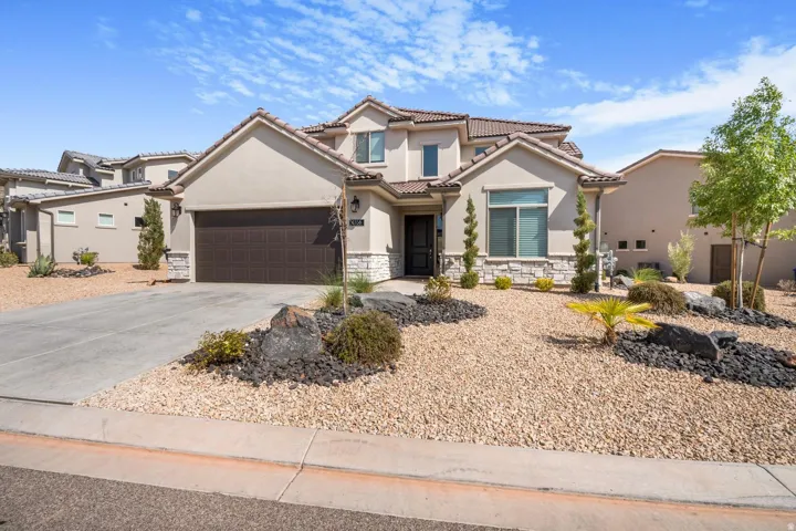 Stucco exterior with stone accents and a tile roof