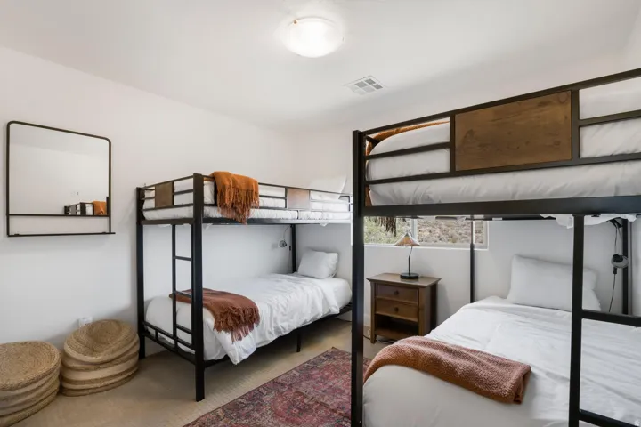 Recessed ceiling lighting, white painted walls, wood-finish flooring, and a window with exterior visibility