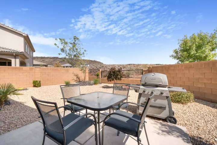 Patio with concrete slab, gravel landscaping, and block perimeter wall