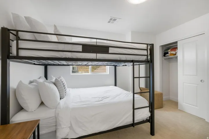 Recessed window with exterior scenery, wall-to-wall carpeting, and a built-in closet with sliding doors