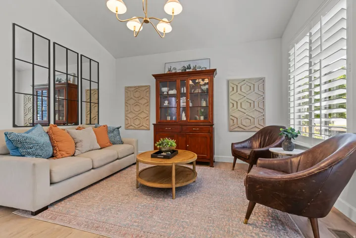 Sophisticated living room showcasing a neutral finishes and warm natural lighting.