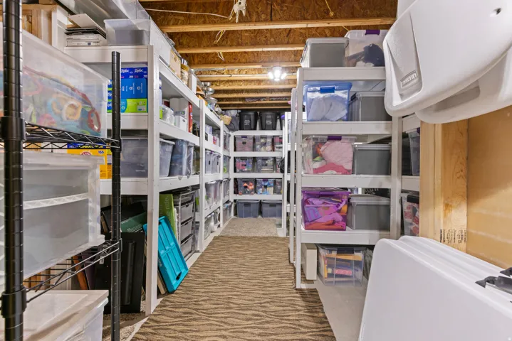 Expansive storage room featuring custom built wood shelving.