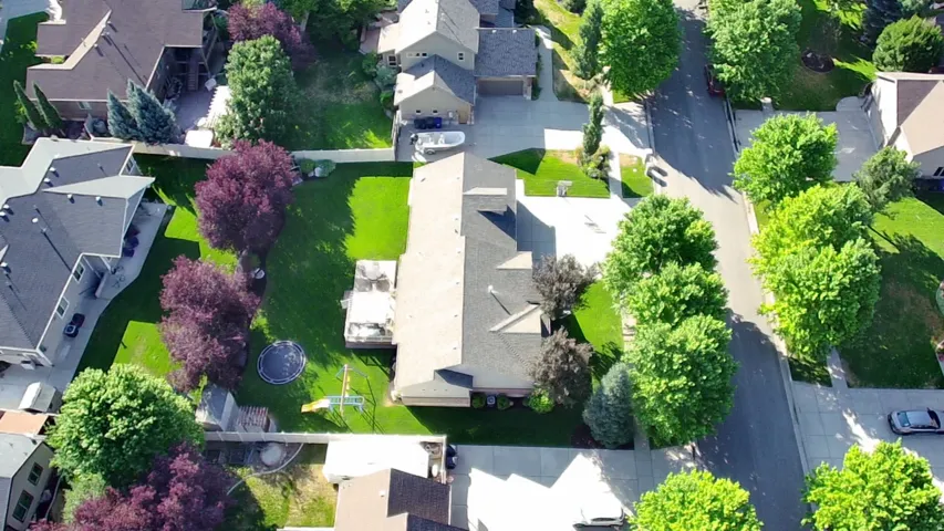 Residential property with a landscaped yard and mature trees