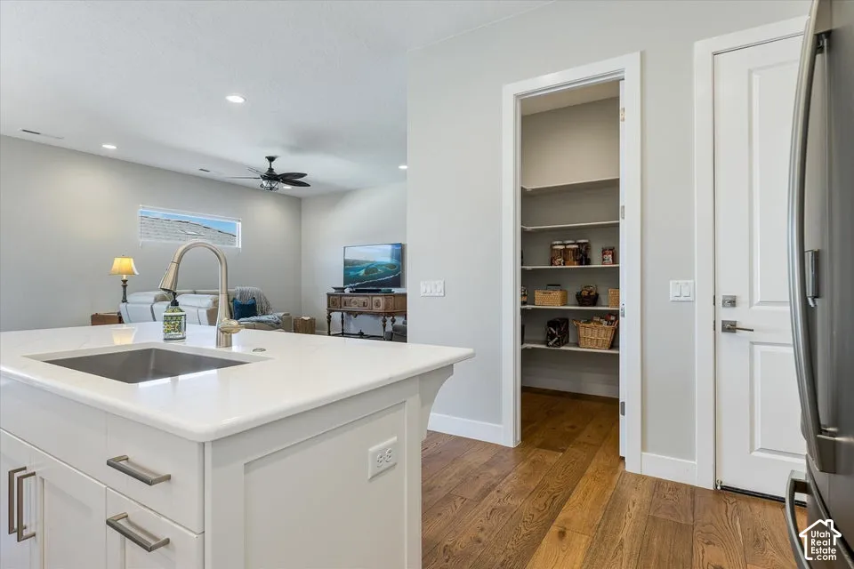 Kitchen island with an undermount sink and a gooseneck faucet