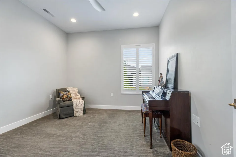 Recessed lighting, ceiling fan, white window shutters, and plush carpet flooring