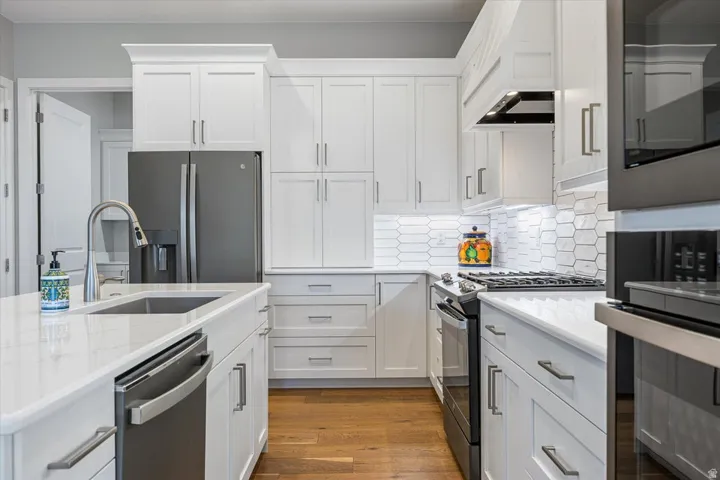 White shaker cabinetry paired with stainless steel appliances