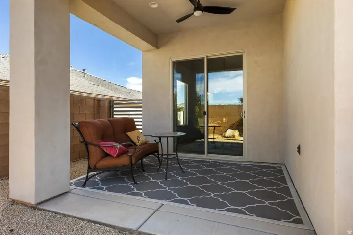 Covered patio featuring a ceiling fan, recessed lighting, and a sliding glass door