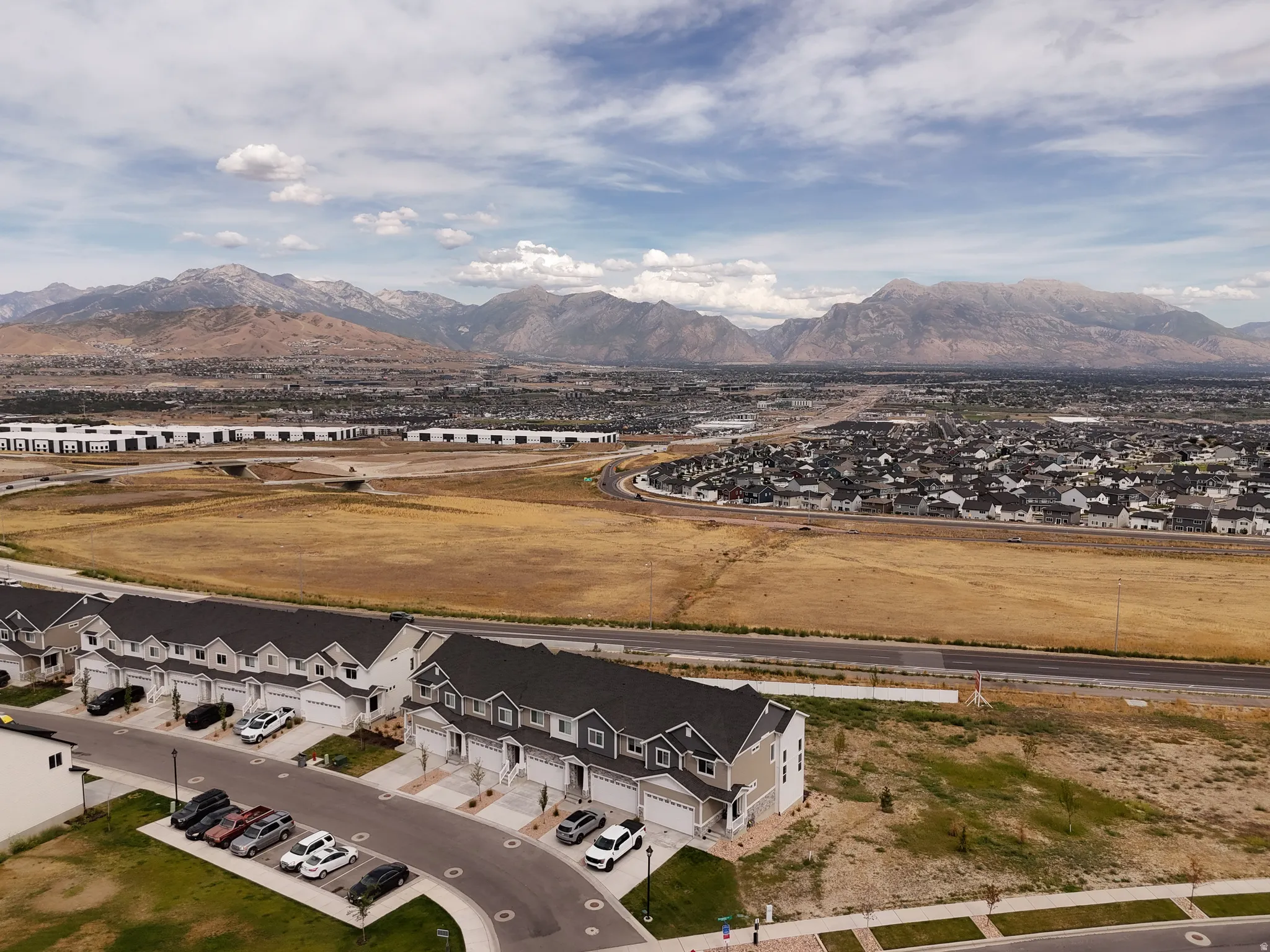 Aerial perspective showcasing a residential development with mountain backdrop