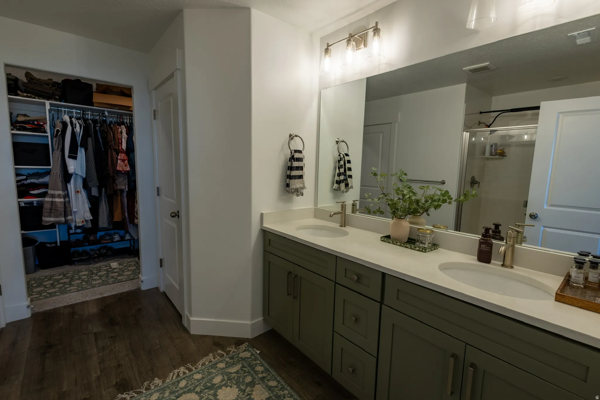 Dual vanity with light-colored countertops and undermount sinks