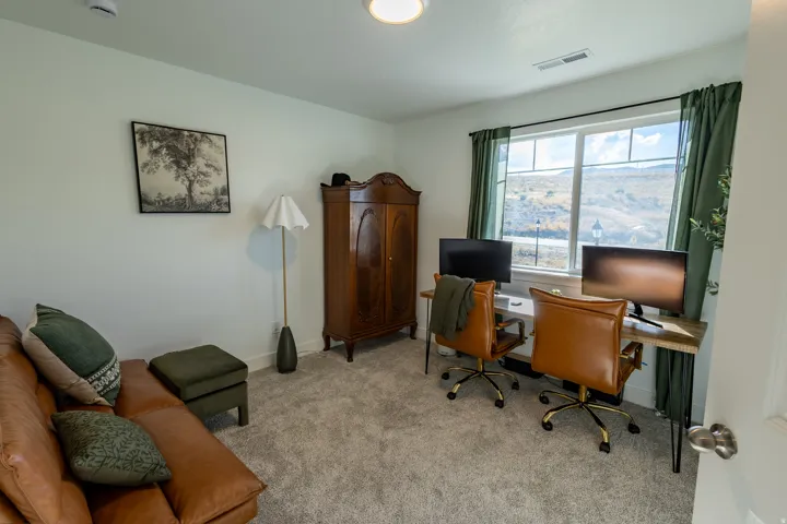 Carpeted room with a double window, built-in recessed lighting, and a prominent wardrobe