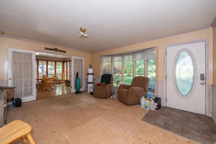 Entry with oval-paneled door and tiled flooring