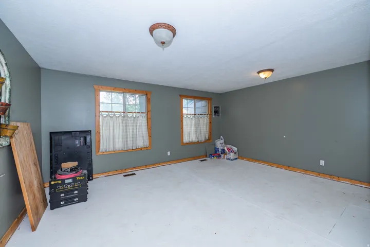 Recessed windows with wood trim, ceiling-mounted light fixtures, and wall-mounted electrical outlets