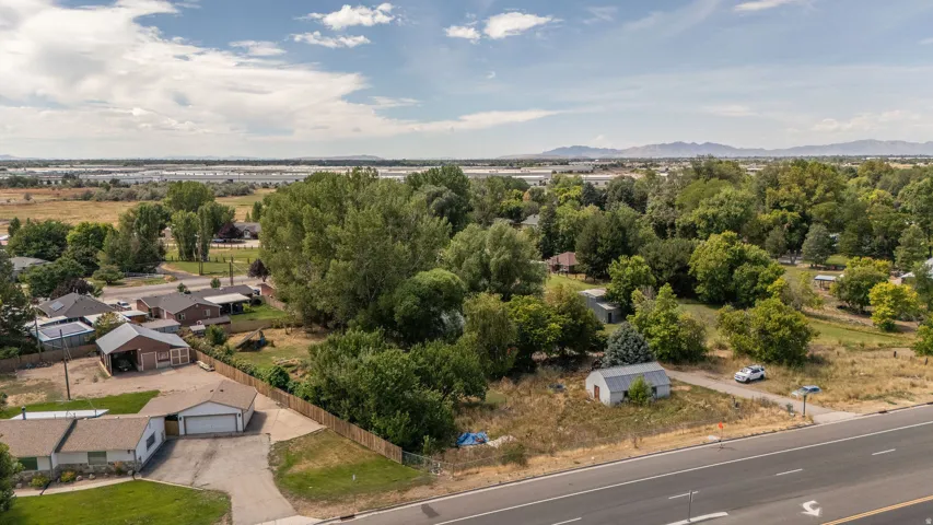 Expansive lot featuring mature trees, a detached garage, and an auxiliary structure
