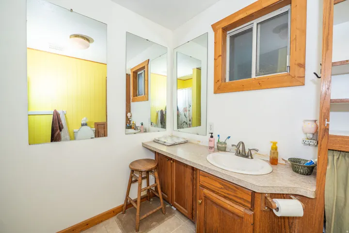 Built-in wood cabinetry with a laminate countertop and an integrated sink