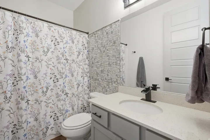 Vanity with a light-toned countertop and an undermount sink