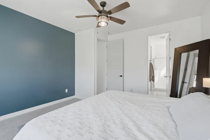 Recessed lighting, ceiling fan with integrated lighting, paneled doors, and light-colored carpeting