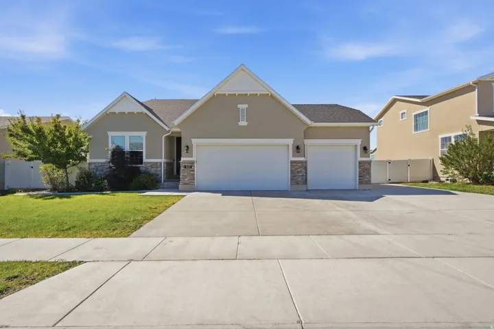 Stucco exterior with stone accents and a two-car garage
