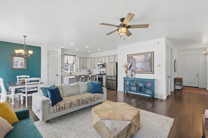 Open concept living space featuring dark wood-finish flooring, a contemporary ceiling fan, and recessed lighting