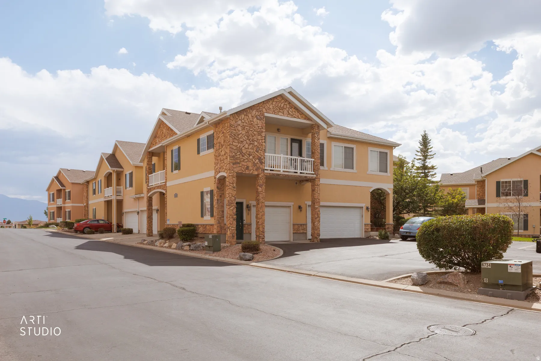 Multi-level exterior with stucco and stone accents