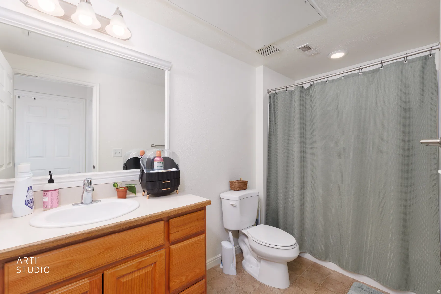 Wood-finish vanity with an integrated sink and chrome faucet