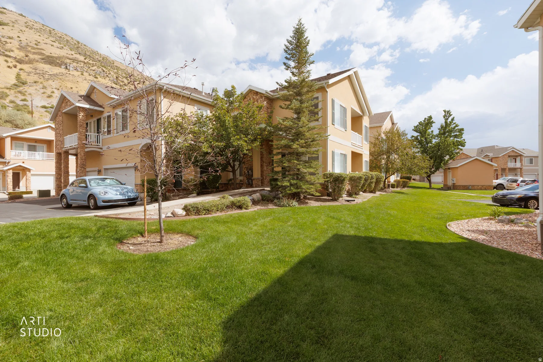 Expansive green lawn with mature trees and landscaped shrubbery