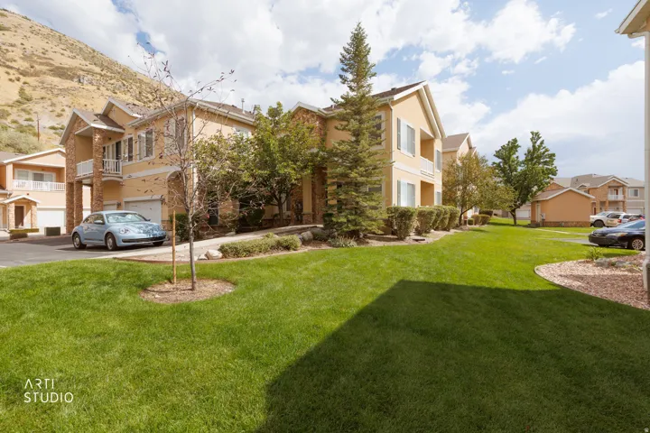 Expansive green lawn with mature trees and landscaped shrubbery
