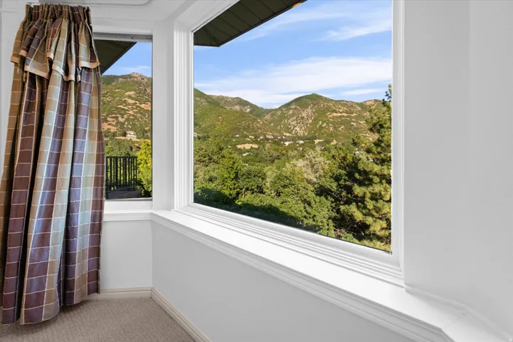 Expansive mountain scenery, white window trim, and wall-to-wall carpeting