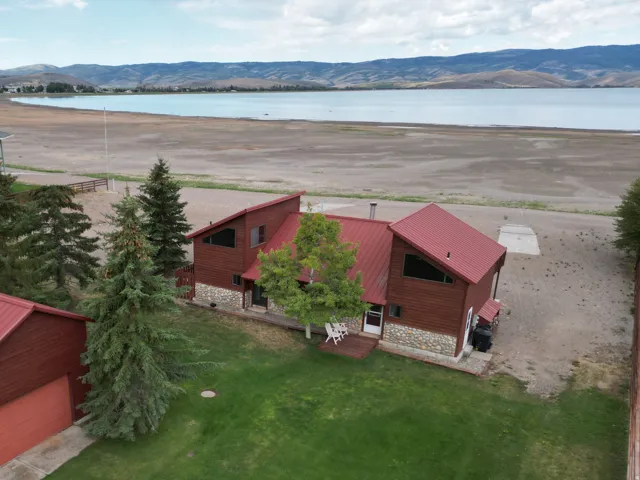 Red metal roof, wood siding, and stone accents on the property