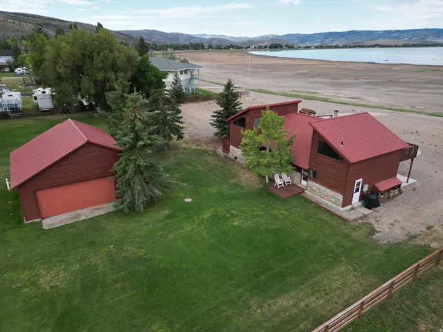 Red metal roof, wood siding, and stone accents