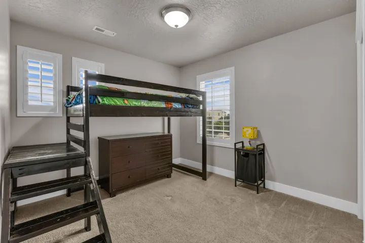Wall-to-wall carpeting and white window shutters
