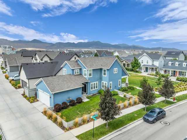 Two-story residence with a detached garage, corner lot, and an expansive lawn
