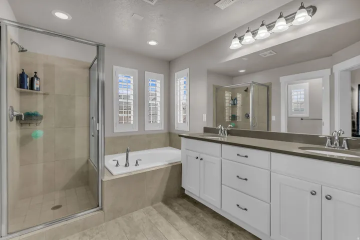 Dual vanity with integrated sinks, framed mirror, and contemporary lighting