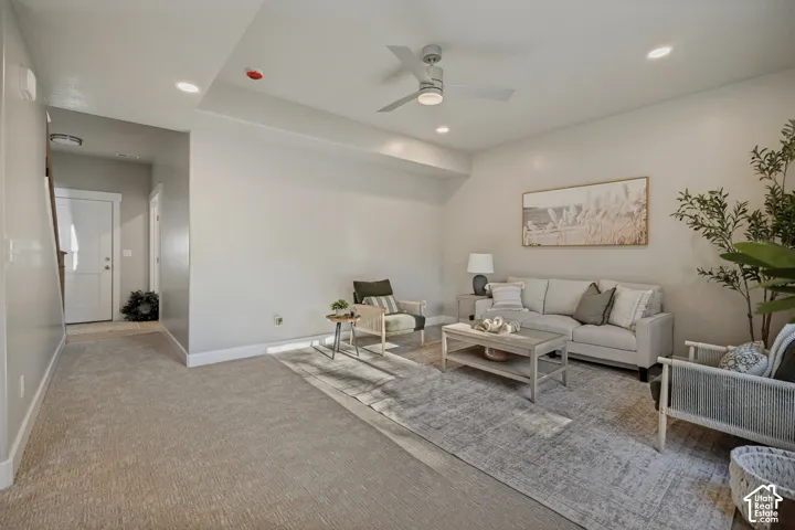 Recessed lighting, contemporary ceiling fan, light neutral wall color, and carpeted flooring