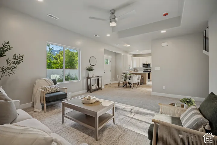 Recessed lighting, ceiling fan, large window, and an open concept layout