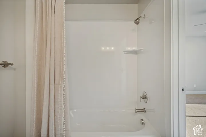Bathtub with a single showerhead and brushed nickel fixtures