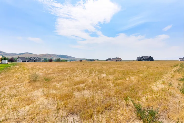 Expansive vacant land with a distant mountain backdrop