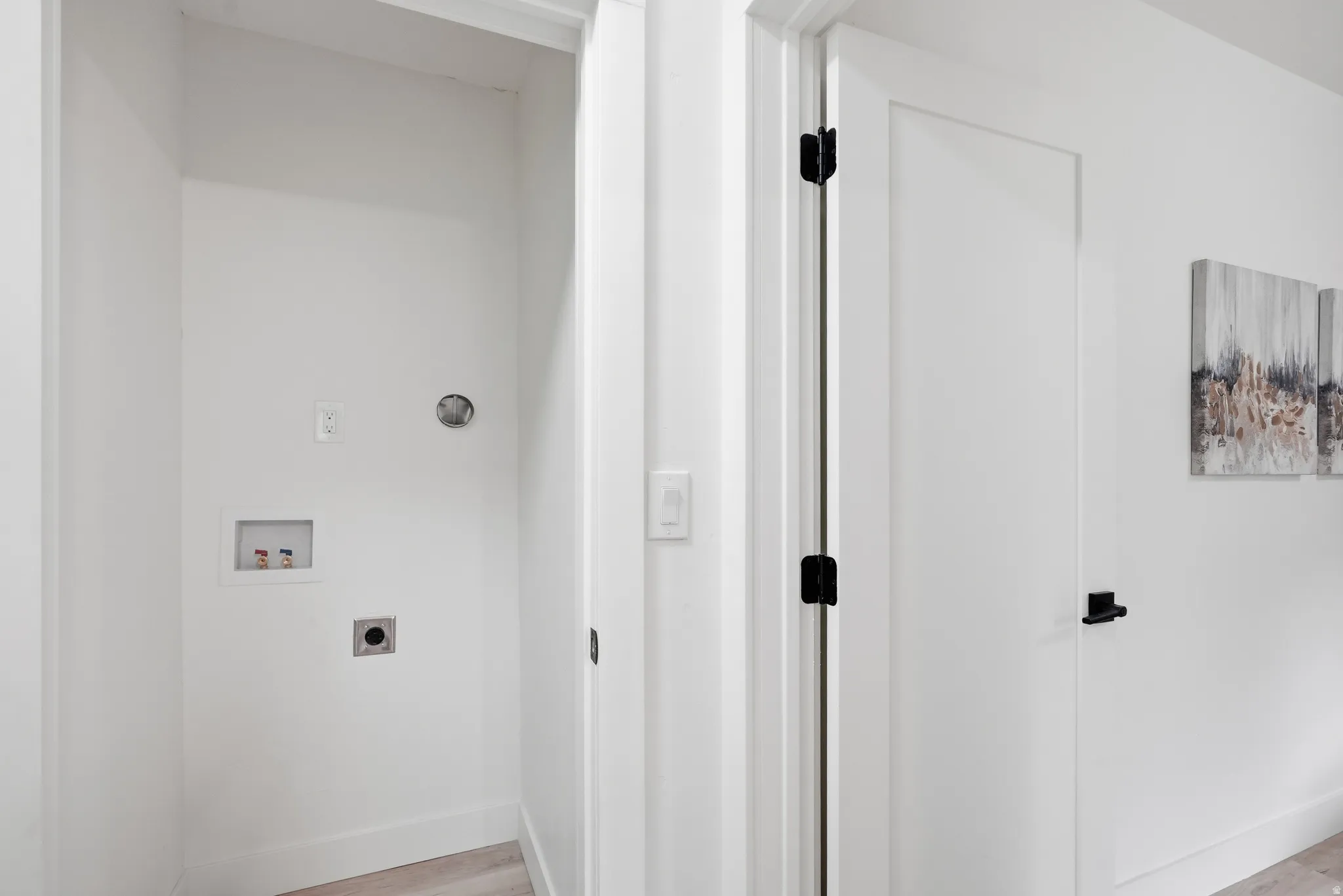 Laundry area with hookups and light wood-finish flooring