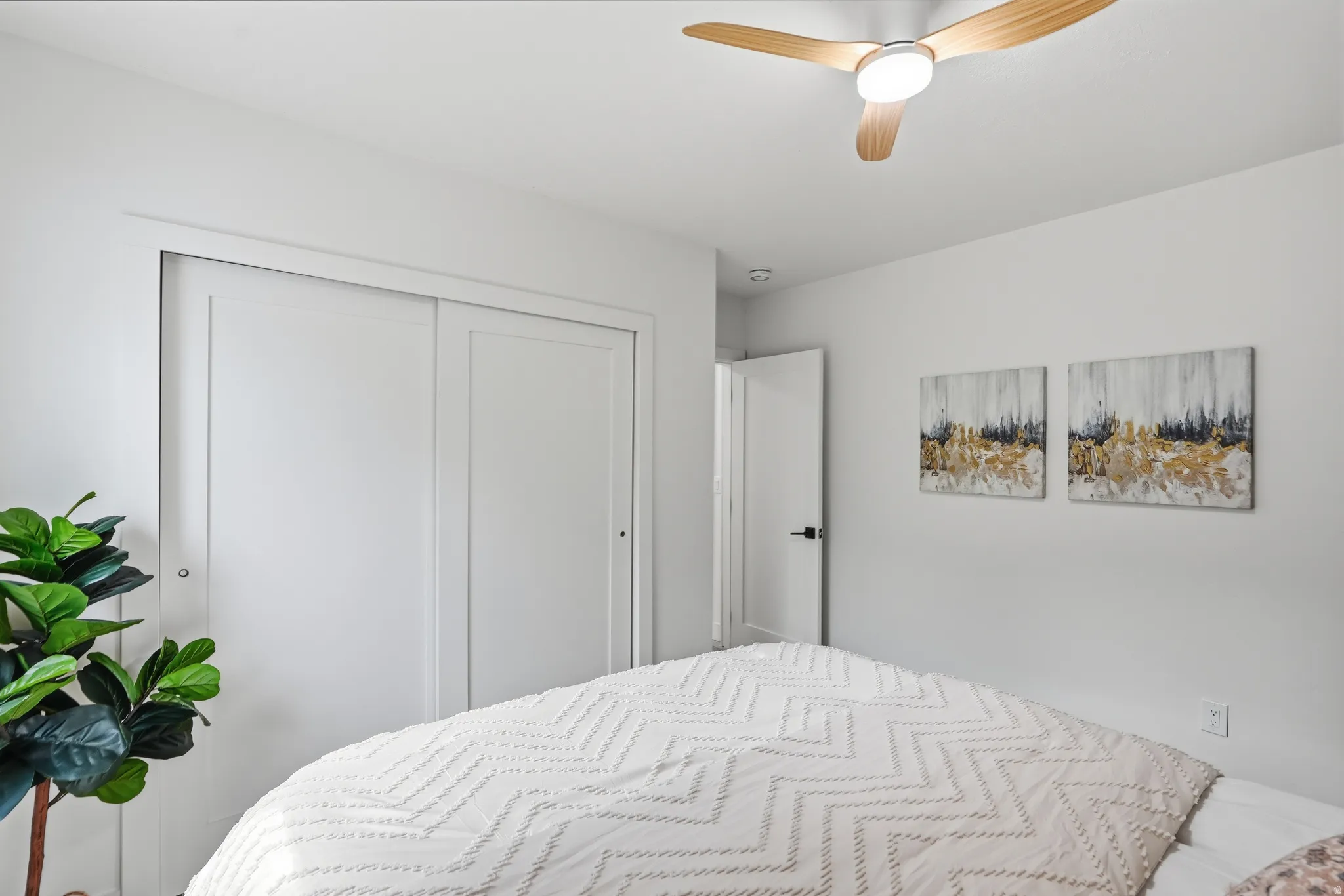 Recessed lighting, wood-finish ceiling fan, white paneled interior doors, and sliding closet doors