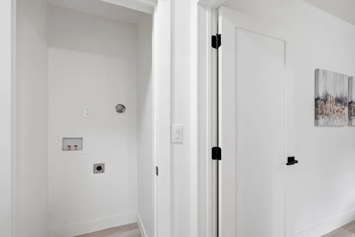 Laundry area with hookups and light wood-finish flooring