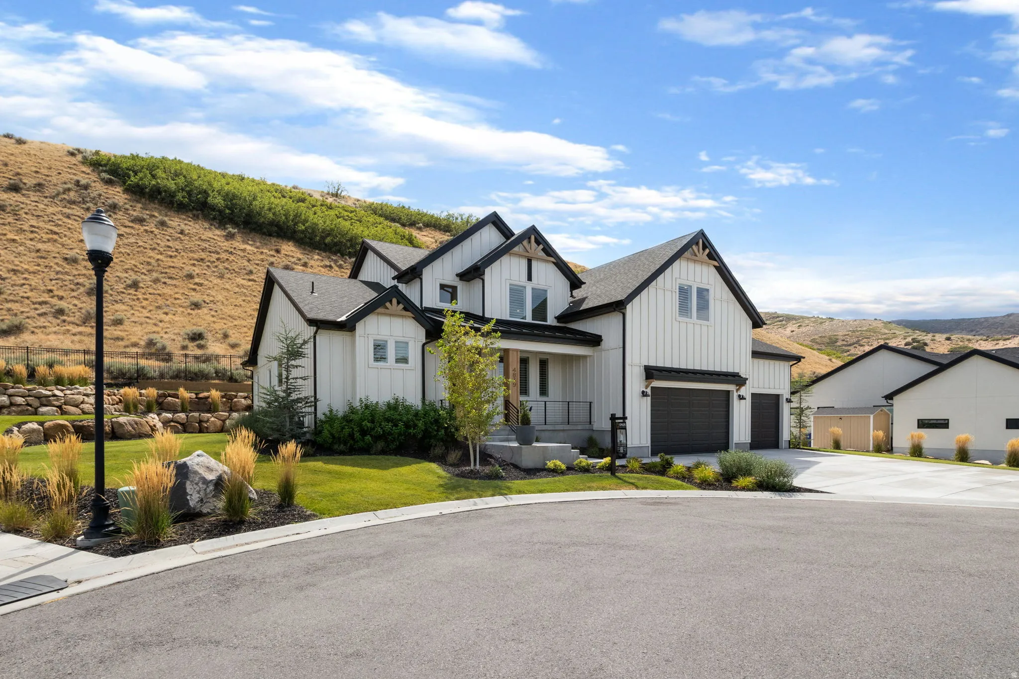 Modern farmhouse exterior with vertical white siding and black trim accents