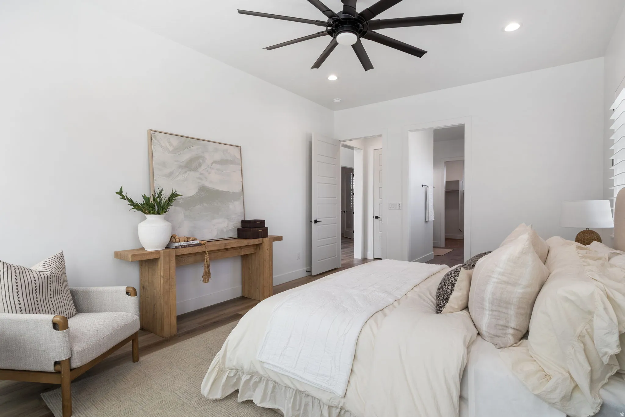 Wood-finish flooring, recessed lighting, and a contemporary ceiling fan