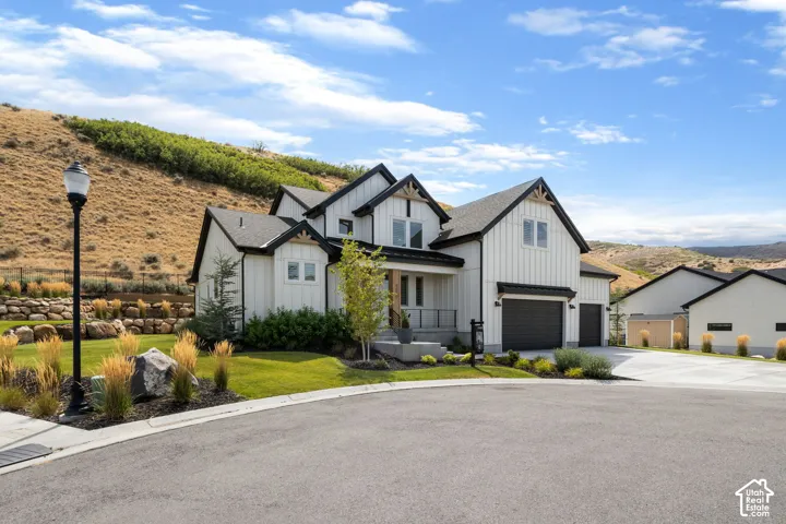 Modern farmhouse exterior with vertical white siding and black trim accents