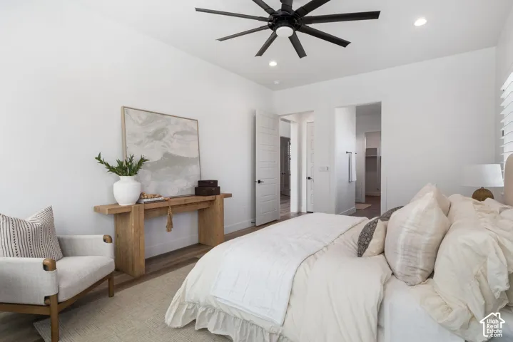 Wood-finish flooring, recessed lighting, and a contemporary ceiling fan