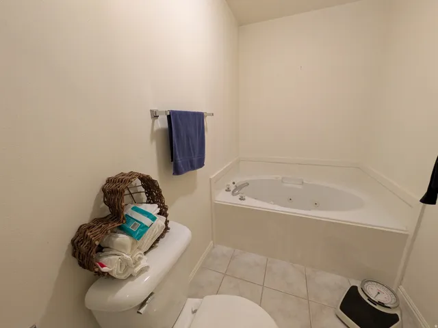 White soaking tub with integrated jets and chrome fixtures