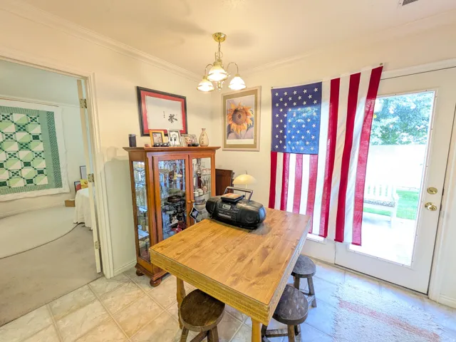 Tile flooring with a flush light wood-finish table and built-in display cabinetry