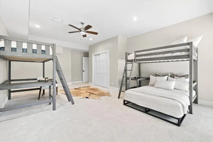 Carpeted room featuring recessed lighting, a ceiling fan, and a built-in closet with bi-fold doors